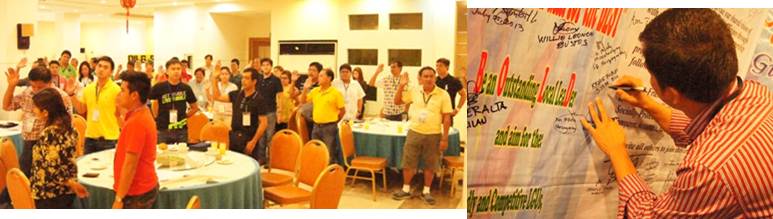 Participants while taking their oaths and signing the Pledge of Commitment